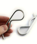 10 Pack Spring Hitch Cotter Hair Pins And White Zinc Plated Retaining Wire Clips For Trailers And Equipment, shown in hand and on surface