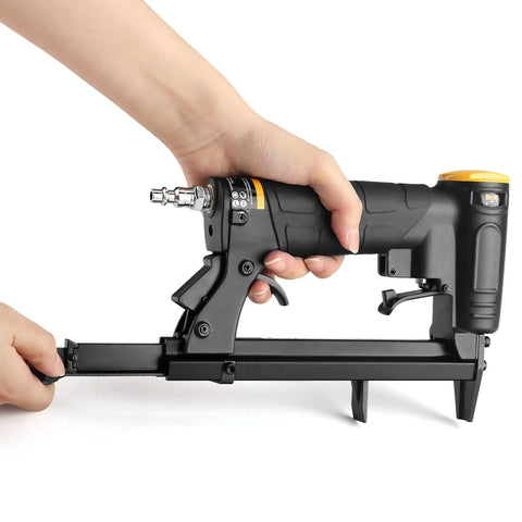 Person holding Lightweight 22 Gauge 3/8 Inch Crown Pneumatic Upholstery Stapler Kit With 6000 Staples, rear exhaust visible