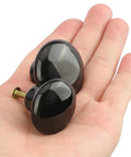 40 Pack Black Ceramic Cabinet Knobs Set With Glossy Mushroom Style Finish, two knobs shown in hand