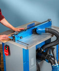 Fence Port Dust Brush For Router Table And Drill Press Cleanup With Flexible Two And Half Inch Hose And Ergonomic Nozzle attached to workspace.
