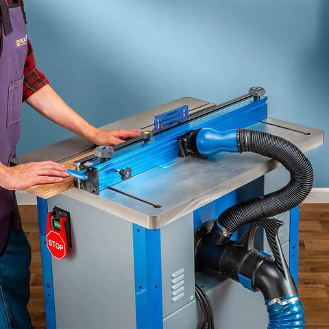 Fence Port Dust Brush For Router Table And Drill Press Cleanup With Flexible Two And Half Inch Hose And Ergonomic Nozzle attached to workspace.