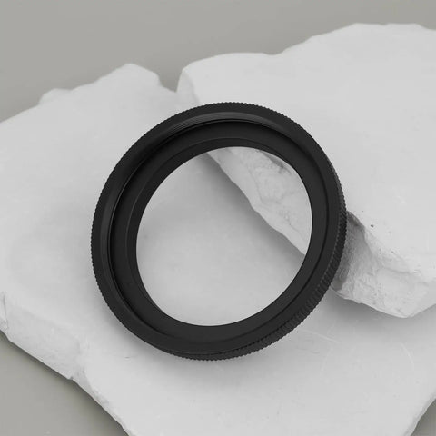 M48 To M54 Telescope Thread Conversion Adapter For Photography Lenses, black aluminum ring viewed on white marble surface.