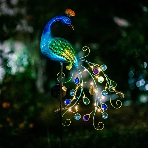 Metal Peacock Solar Garden Lights Stakes, Waterproof Path Lights, peacock design glowing at night in yard decor setting