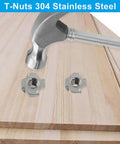 Top Shelf Four Pronged Tee Nuts Forged From Heavy Duty 304 Stainless Steel Matching 3 8 16 Thread Size Plus 7 16 Inch Barrel Depth Dead Simple Setup On Wood Furniture Cabinetry And Rigging Pro Grade 25 Pack with hammer and wooden surface.