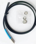 FU610 Fiber Optic Sensor with 1 meter black cable and M6 probe, for diffuse reflective digital sensing, shown with nuts and washers