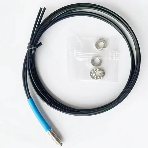 FU610 Fiber Optic Sensor with 1 meter black cable and M6 probe, for diffuse reflective digital sensing, shown with nuts and washers