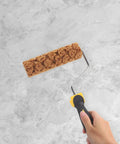 Pineapple Texture Sponge Paint Roller for Walls Gives Your Home a Major Glow Up with This DIY Decor Tool showing textured roller on a marble background.