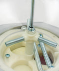 Close-up of the inner mechanics of a Dead On Pink Twister Ball Dispenser with steel screws and white plastic components.