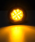Close-up of 2.5 Inch Round Amber LED Marker Lights With Reflectors, 13 LEDs illuminated, showing brightness and grommet details.