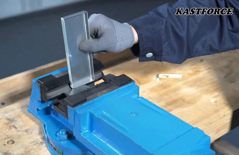 Person using 6 Inch Vise Mount Metal Brake Bender Attachment For 4 Inch Or Wider Vises That Bends 14 Gauge Steel And Two Millimeter Mild Steel, Also Handles One Eighth Inch Aluminum, With Removable Hardened Finger Dies One, Two, Three Inches on a blue vise.