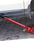 Rock Solid Vertical Hydraulic Bottleneck Jack For Cars 5 To 10 Ton Capacity Red Compact Portable Design With Tough Carbon Steel Handle in use under vehicle.