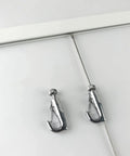 Click Rail Picture Hanging System Kit with two steel cables and chrome hooks attached on a white rail for gallery walls