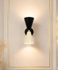 Mid-Century Two-Tone Cone Wall Sconce Light - Black & White Dual Funnel Wall Mounted Lamp with Gold Accent Ring - Up and Down Wall Lighting Fixture for Living Room & Bedroom mounted on wall, casting warm light.