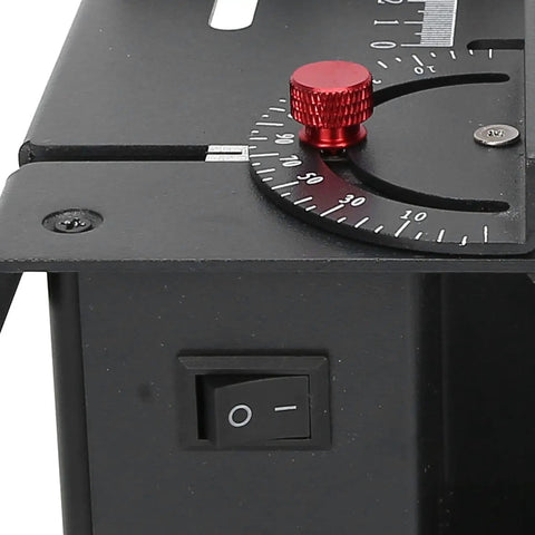 Close-up of the Top Pick Mini Table Saw With A Slick 25 Piece Cutting Kit showing the adjustment dial and power switch.