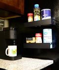 2 Pack Magnetic Shelves For Washer And Fridge Each Holds 12 Lbs Black Steel Kitchen Organizer For Spices Jars Vitamins And More Space Saving Magnetic Rack For Laundry Room And Pantry shown installed holding spices and jars on fridge.