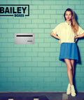 Franklin Wall Mounted Locking Mailbox In Stainless Steel Modern Design with weather resistant finish on a blue brick wall