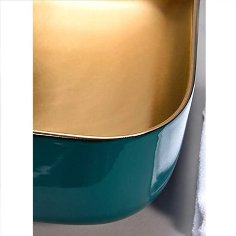 Above counter vessel sink in teal porcelain with glossy gold interior, 50X40X13 cm, enhances any bathroom as a smooth operator.