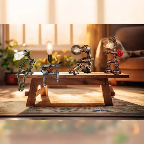 Steampunk Robot Pipe Desk Lamp With Vintage Industrial Edison Lighting, Bronze Metal Finish, Red Valve on a wooden table