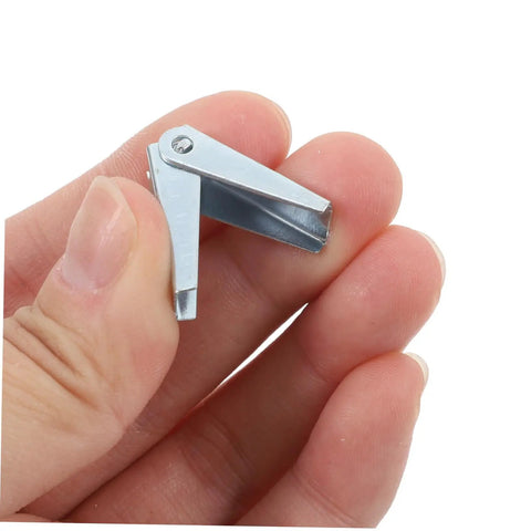 Hand holding a zinc plated steel toggle wing nut for drywall mounting, part of Heavy Duty Zinc Plated Steel Toggle Bolt And Wing Nut Kit For Secure Drywall Mounting, Easy Install, High Load Capacity, 60 Pack For Wall Brackets, Shelves, TVs, And Microwave Mounts.