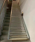 Heavy Duty Waterproof Roller Conveyor System Made From Stainless Steel 304 positioned on stairs for easy material transport.