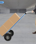 Rugged Aluminum Folding Hand Truck And Rolling Dolly Cart With 500 Pound Capacity carrying boxes with 10-inch pneumatic tires.