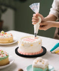 Person decorating cake on 8 Inch Heavy Duty Rotating Swivel Stand With 360 Degree Rotation And Steel Ball Bearings.