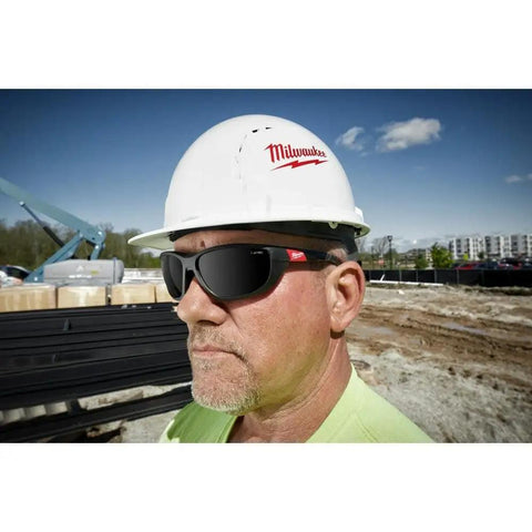 Worker wearing rectangular polarized high performance safety glasses with gasket black eye protection for work and DIY projects
