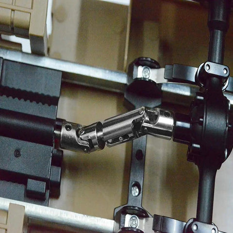Close-up of metal drive shaft upgrade kit for 1/16 scale WPL RC trucks showing smooth power transfer mechanism