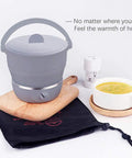 Foldable Electric Travel Hot Pot For Camping And Office, Dual Voltage 100V-240V, on wooden board with soup and pouch