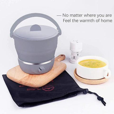 Foldable Electric Travel Hot Pot For Camping And Office, Dual Voltage 100V-240V, on wooden board with soup and pouch
