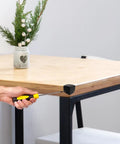 16 Pack Real Deal Metal Corner Protectors For Cabinets And Boxes Chrome Plated Heavy Duty Edge Guards With No Sweat Install Hardware Included Top Shelf Protection For Your Gear shown being installed on a wooden table corner.