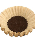 Hella Durable Unbleached Brown Biodegradable Coffee Filters Fit 10 To 15 Cup Baskets Extra Wide with coffee grounds inside.