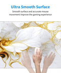 Hands using Boss Size Desk Pad For Gaming And Work 31.5 By 11.8 Inches Waterproof Thick Desk Mat With Grippy Non Slip Rubber Base White Gold Marble Flower