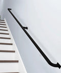 Sick Heavy Duty Black Metal Handrail For Stairs Wall Mounted Banister Rock Solid Wrought Iron Railing on white wall above steps.