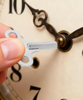Hand using Universal Clock Winding Keys Kit For Old School Mechanical Clocks And Alarm Clocks In Stainless Steel Two Pack