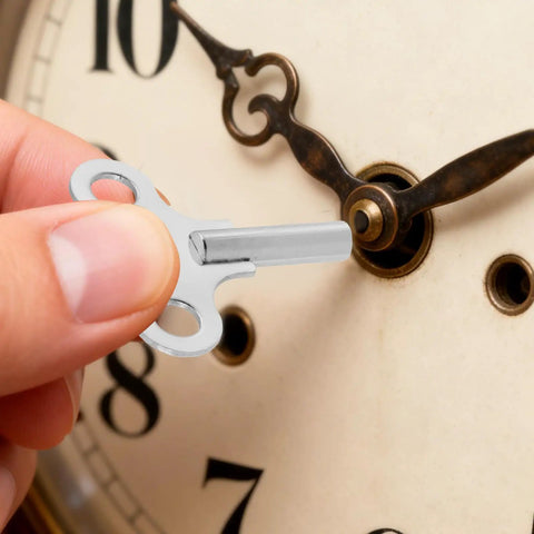 Hand using Universal Clock Winding Keys Kit For Old School Mechanical Clocks And Alarm Clocks In Stainless Steel Two Pack