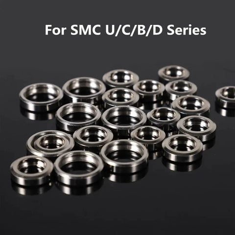 Small Industrial Manipulator Pneumatic Vacuum Pad Accessory Copper Buckle Ring For Heavy Duty Grip And Secure Attachment In Factory Settings metal rings arranged on a surface.