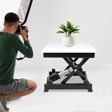 Heavy Duty Electric Scissor Lift Table With No Sweat 130 Lbs Raising Action Smooth Height Adjust From 7 To 16 Inches with a plant