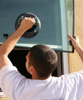 Person using 8 Inch Suction Cup with Metal Handle for lifting glass, demonstrating Heavy Duty Vacuum Mount for smooth nonporous surfaces.