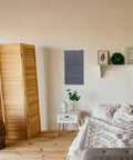 Double Sided Hanging Storage Organizer With Thirty Pockets For Socks Underwear And Clothes Dorm Room Door Wall Mount Space Saving Closet Sorter Game Changer For Tucking Away Clutter Fast Level Up Your Bedroom Setup on a wall in a cozy bedroom.