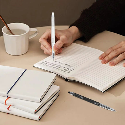 Person writing in notebook with Extra Fine 0.28mm Gel Pens Black Ink Go To School Office Set With Transparent Tube Case Six Pack