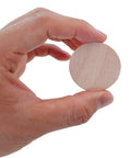 Hand holding a 1.5 inch Solid Quality Natural Wood Rounds Unfinished Craft Discs for DIY Projects.
