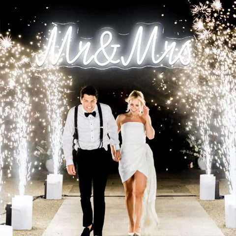 LED Wedding Neon Sign Wall Decor For Engagement Party And Valentines Day Cold White Glow with 'Mr & Mrs' text at a wedding.