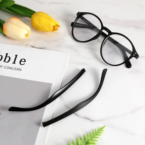 DIY Glasses Temple Replacement Arms Kit With Screws, Washers, Screwdriver And Nose Pads TR90 Eyeglasses Repair Set In Black. Includes black TR90 arms next to eyeglasses on a marble surface.