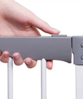 Close-up of hand operating a latch on the Royale Converta 3 In 1 Play Yard And 151 Inch Wide Baby Gate, showing gray latch mechanism.