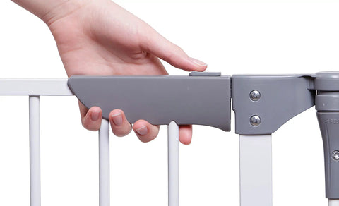 Close-up of hand operating a latch on the Royale Converta 3 In 1 Play Yard And 151 Inch Wide Baby Gate, showing gray latch mechanism.