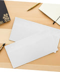 White 100 Pack Self Seal Envelopes With Peel And Seal Privacy Protection on desk with pens and notebooks