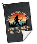 Not All Who Wander Are Lost Golf Towel with Bigfoot design, polyester and cotton, 60x40 cm, with carabiner for easy golf bag attachment.