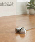 Heavy 2.2 Lb Stainless Steel Door Stop Wedge With Brushed Finish Floor Holder for hardwood and tile, holding glass door open.