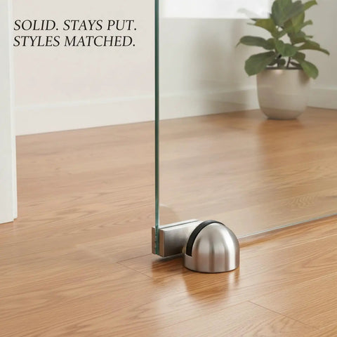 Heavy 2.2 Lb Stainless Steel Door Stop Wedge With Brushed Finish Floor Holder for hardwood and tile, holding glass door open.